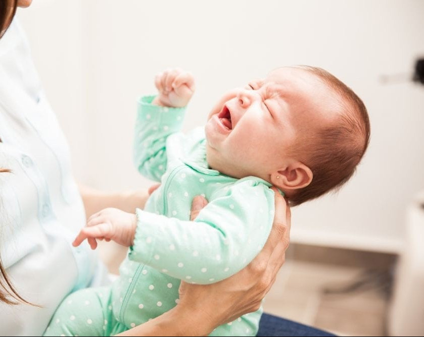 Should I wait for the baby to cry before feeding at night?