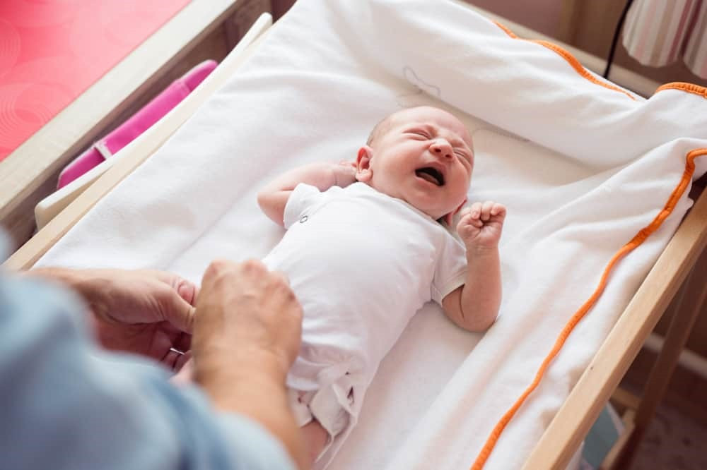 Do all newborns cry during a diaper change?