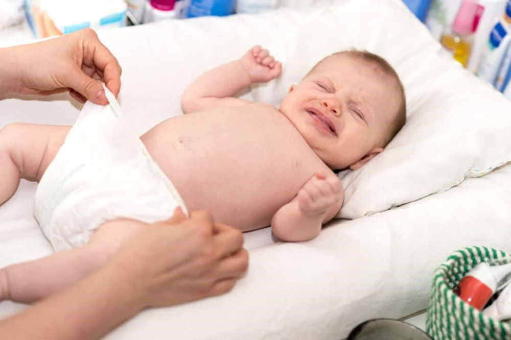 Do all newborns cry during a diaper change?