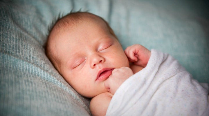 Should I keep the baby swaddled during night feedings?